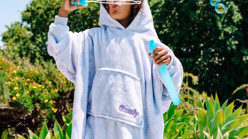 kid blowing bubbles, wearing The Comfy