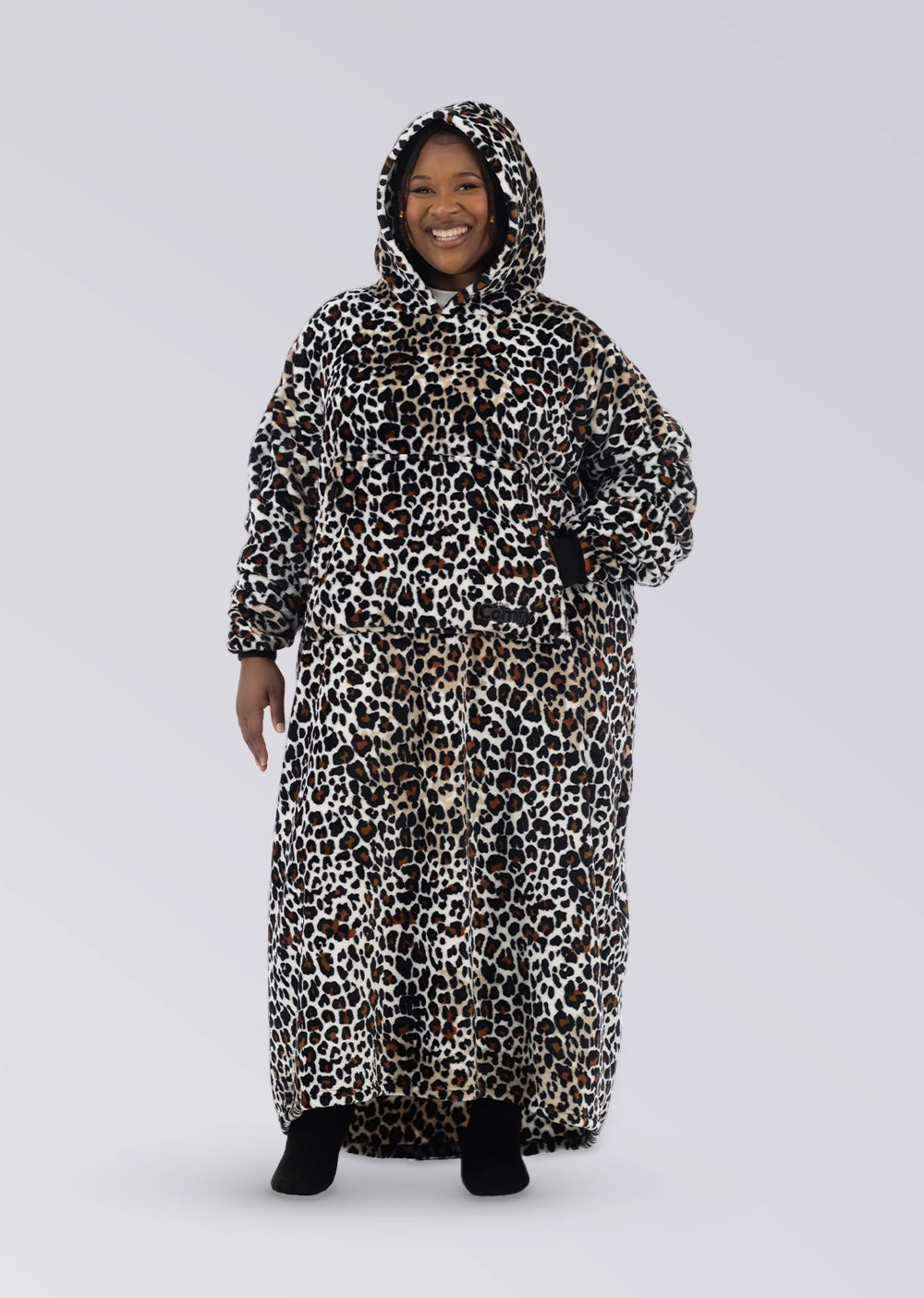 Front view of a woman wearing The Dream Long in Leopard with the hood up and one hand on her hip.