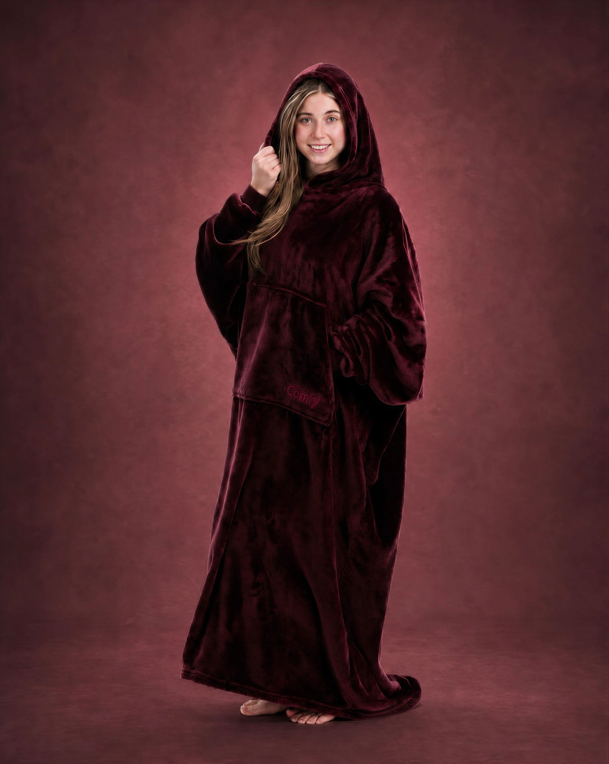 Woman wearing The Dream Long in Burgundy with hood up, showcasing the relaxed fit and full-length coverage.