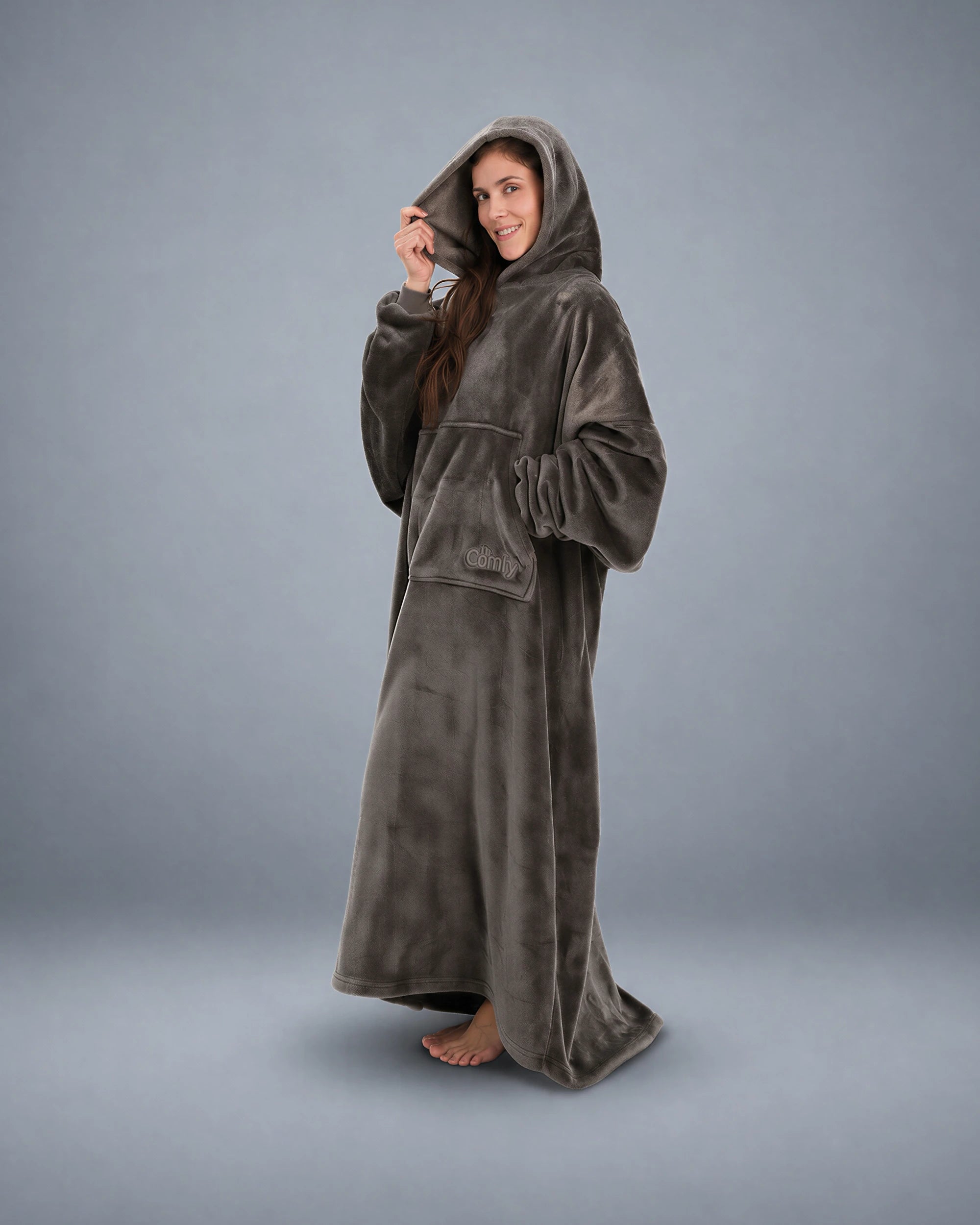 Side-profile view of a woman wearing The Dream Long with the hood up, highlighting the relaxed drape, oversized fit, and cozy kangaroo pocket.