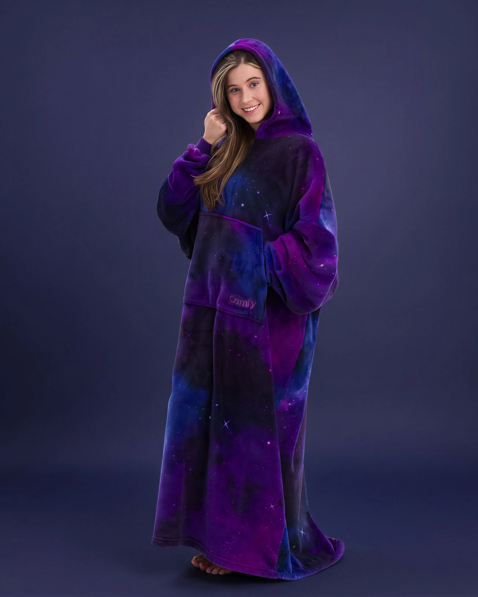 Woman wearing The Dream Long in Galaxy with hood up, highlighting the oversized fit and celestial-inspired purple and blue design.