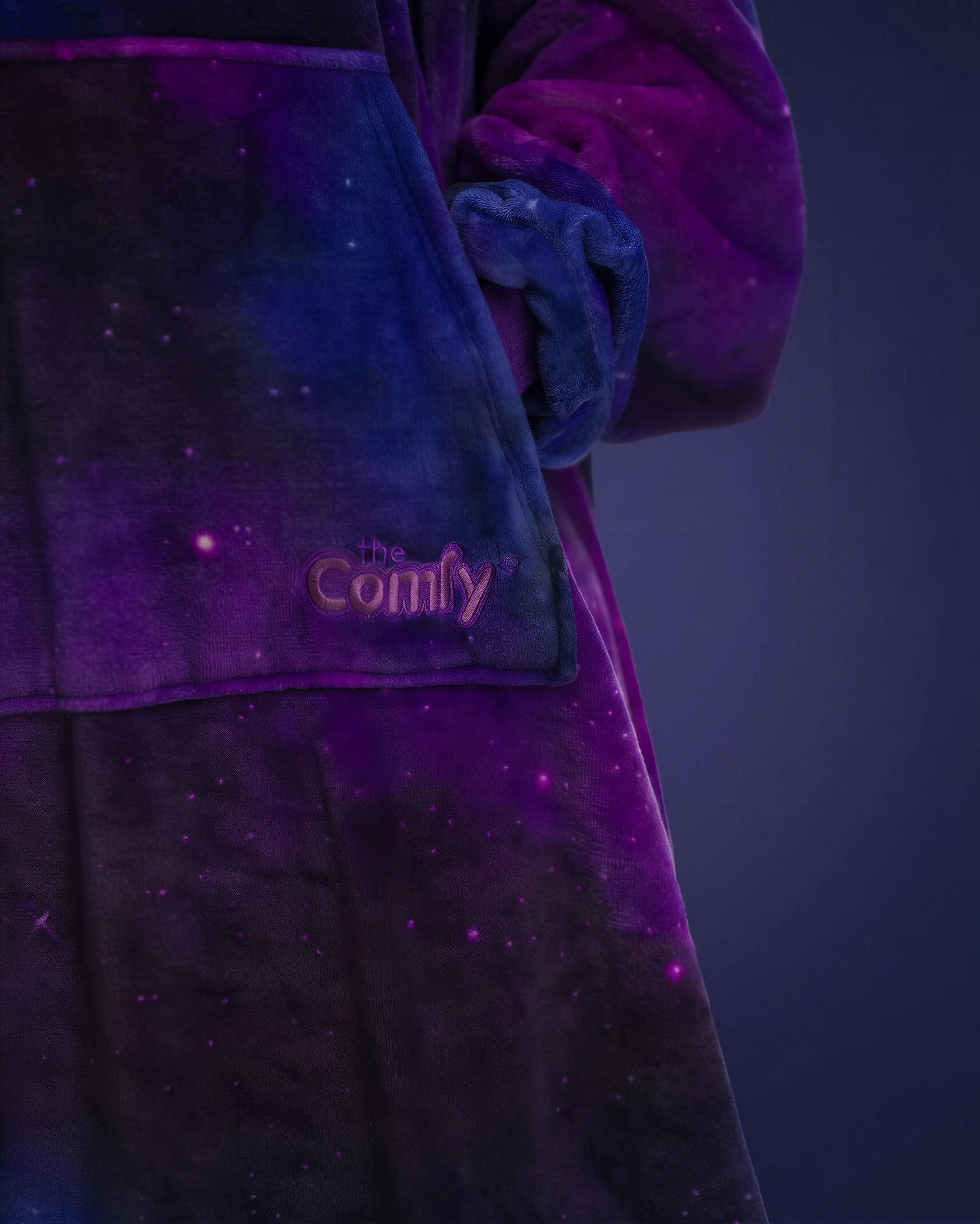 Close-up of The Dream Long in Galaxy featuring the soft microfiber fabric, embroidered The Comfy logo, and star-filled cosmic print.