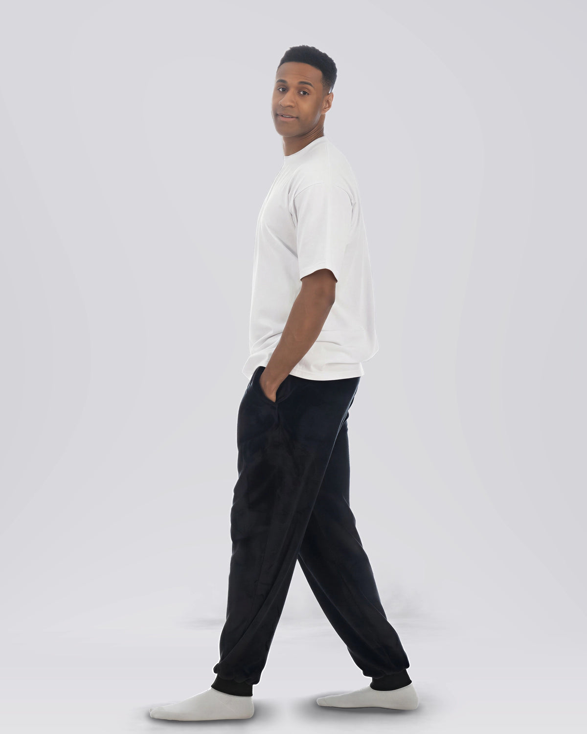 Model walking while wearing The Dream Pants in Black.