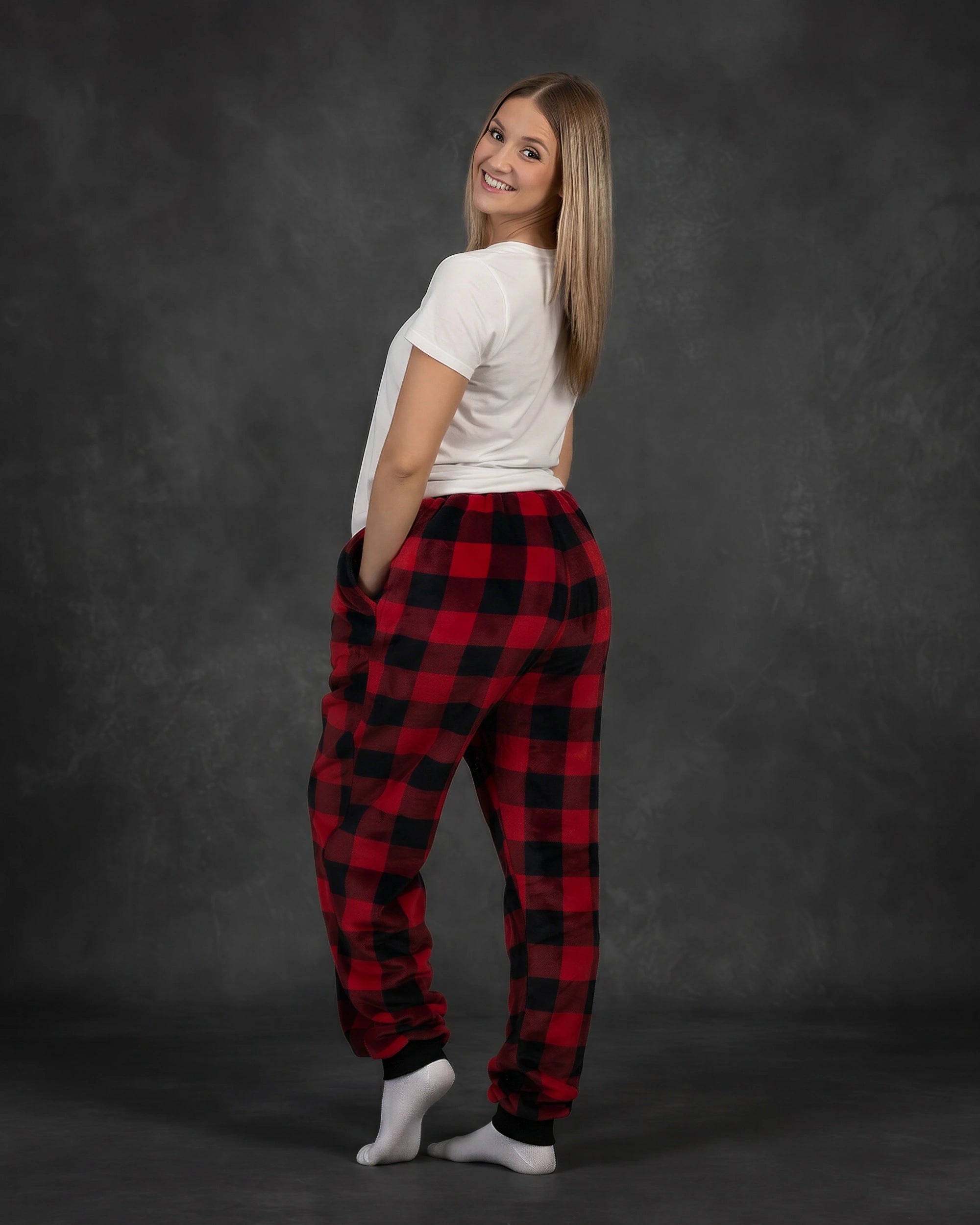 Rear three-quarter view of a woman wearing Dream Pants in Red Plaid, highlighting the relaxed silhouette and all-over buffalo check design.