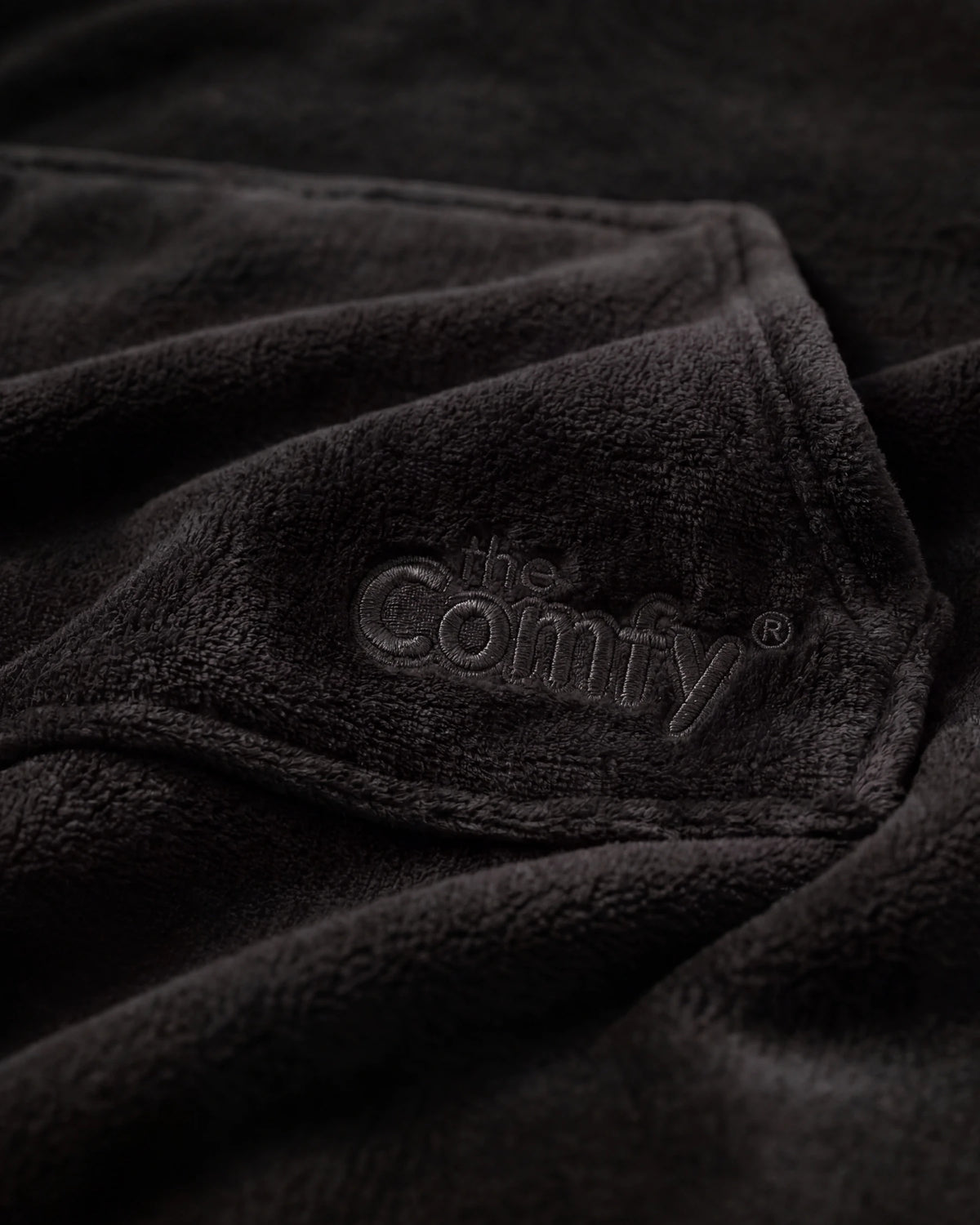 Close-up of The Dream in Black showing DreamHaven™ fabric, the kangaroo pocket, and tonal Comfy embroidery.