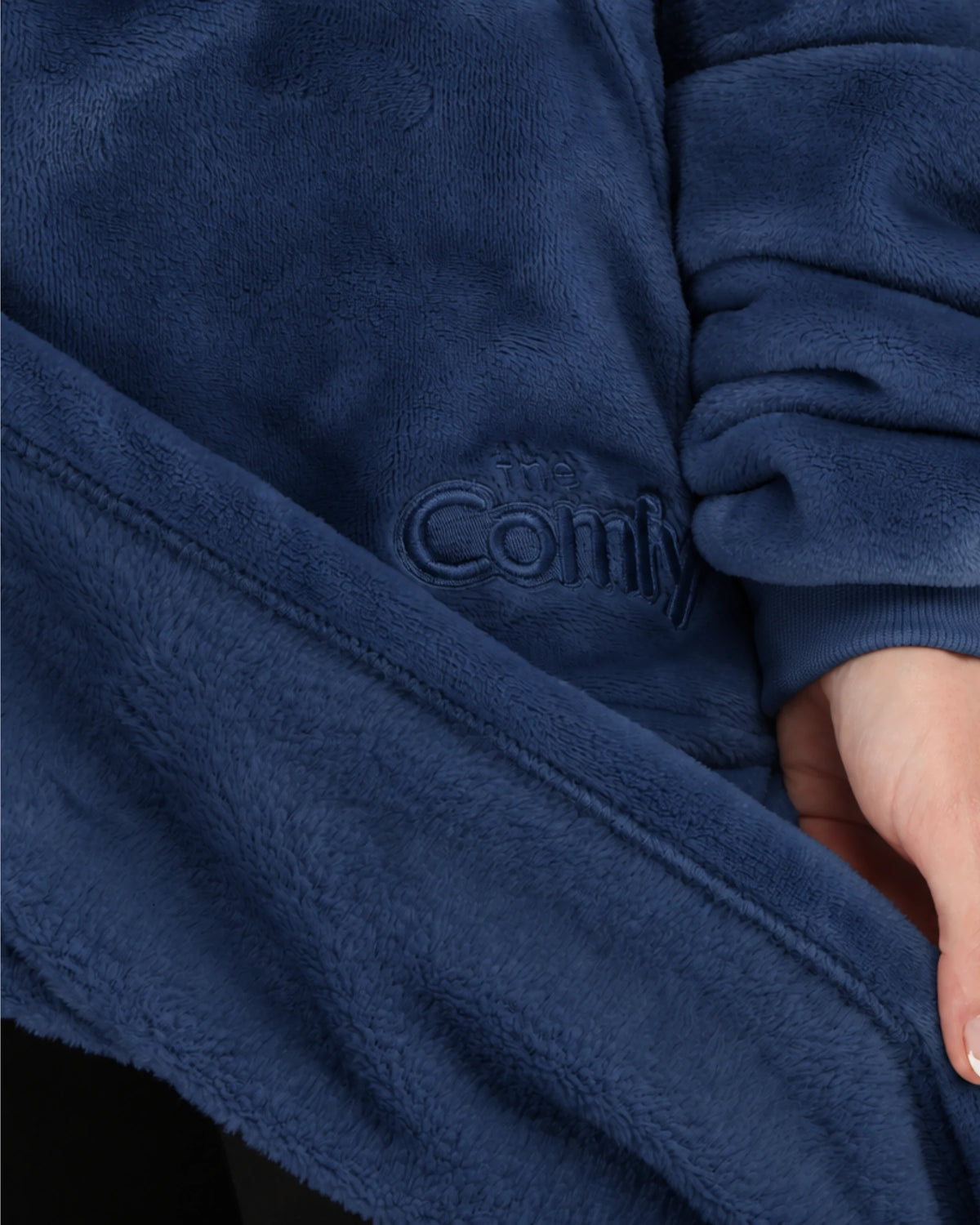 Close-up of The Dream in blue showing its fabric and embroidered logo.