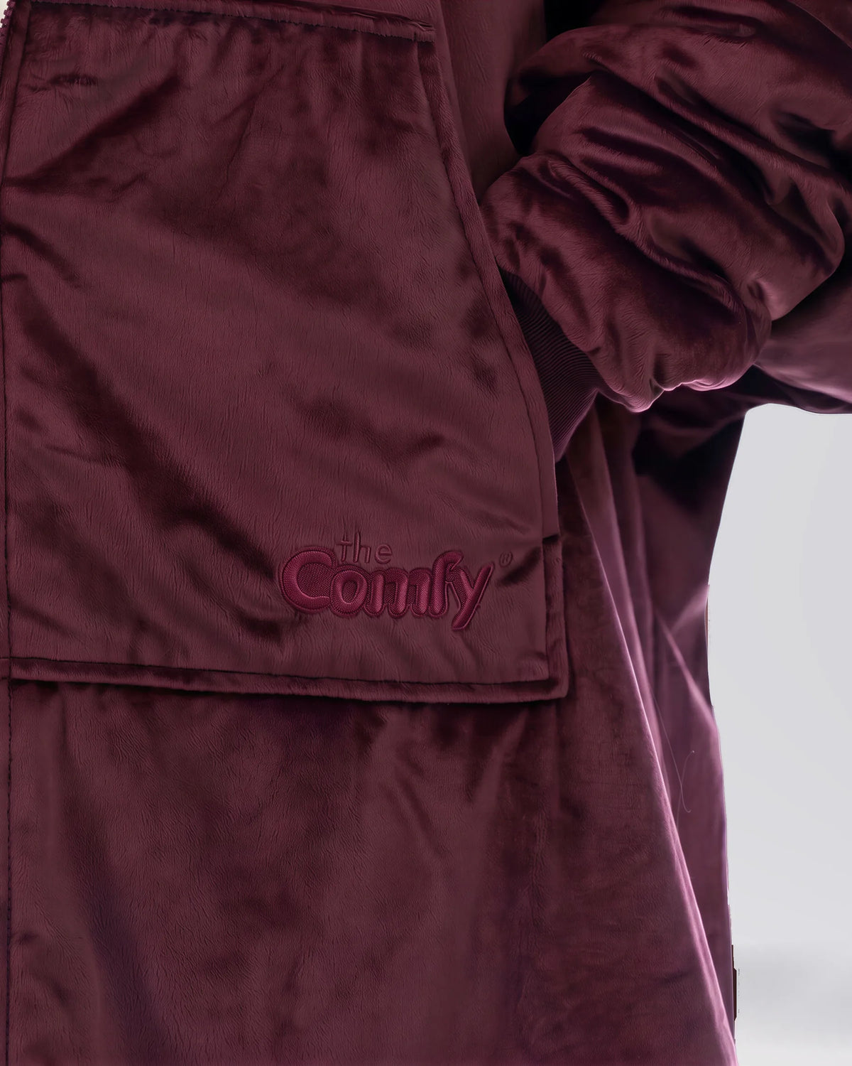 Close-up of The Original Full-Zip Burgundy wearable blanket featuring embroidered The Comfy logo and Velveluxe™ fabric.