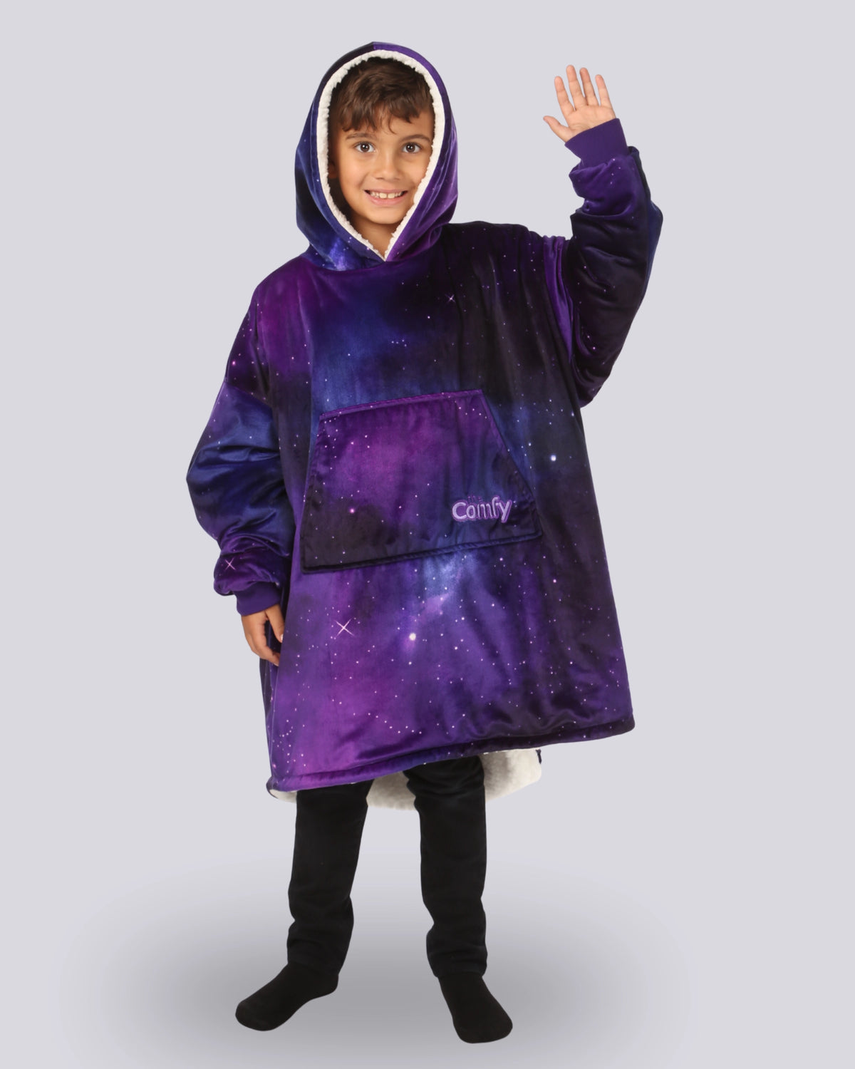 Child wearing The Original Jr. Galaxy wearable blanket in a waving pose, highlighting the oversized hood, kangaroo pocket, and cozy comfort.