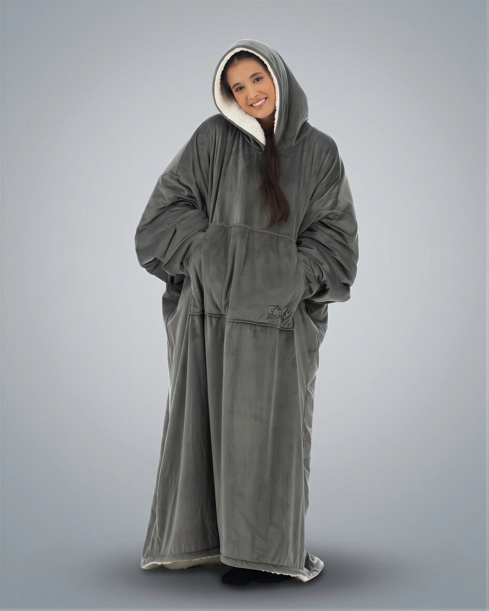 Woman wearing The Comfy Original Long in charcoal in a relaxed standing pose with hood up.