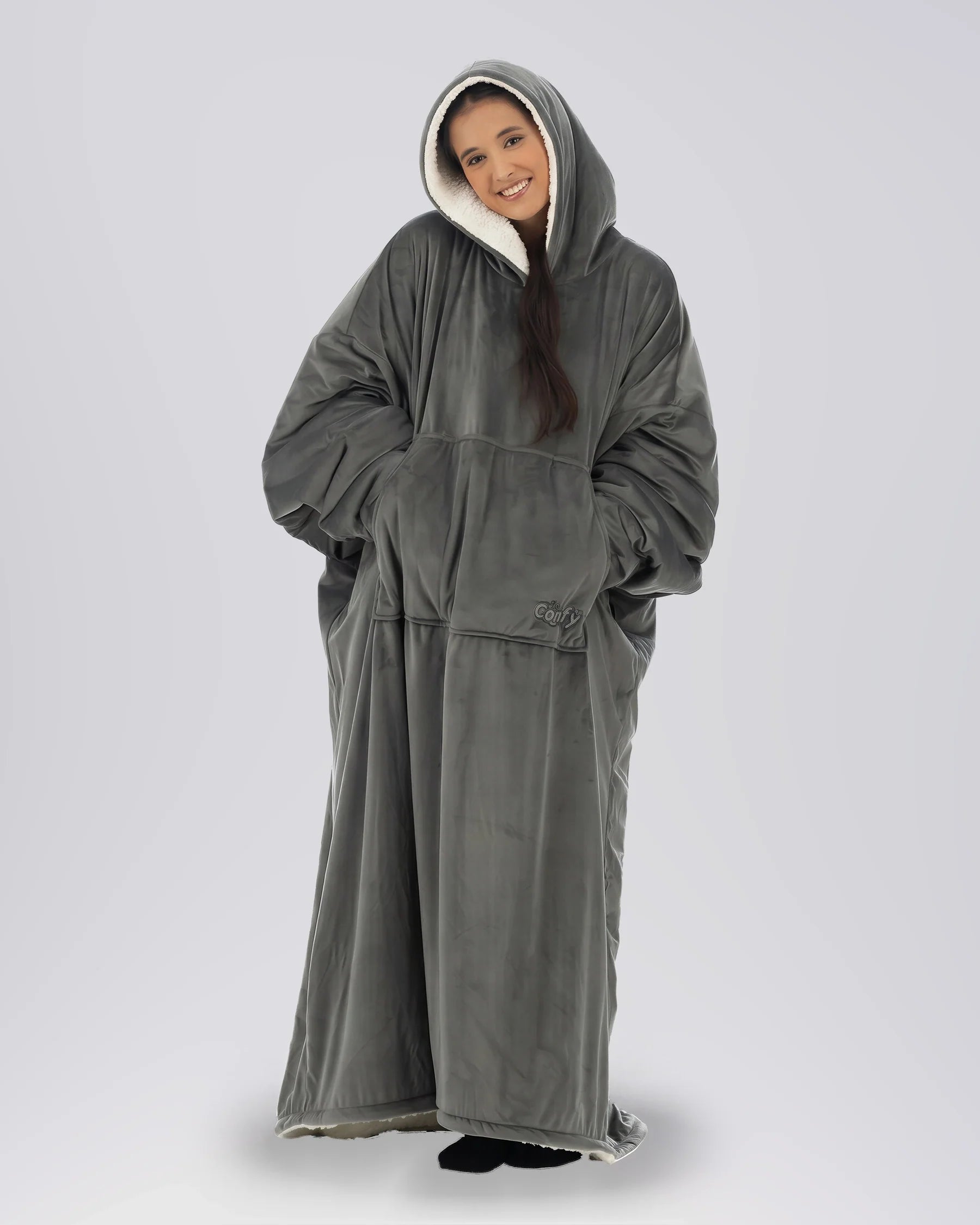 Woman wearing The Comfy Original Long in charcoal in a relaxed standing pose with hood up.