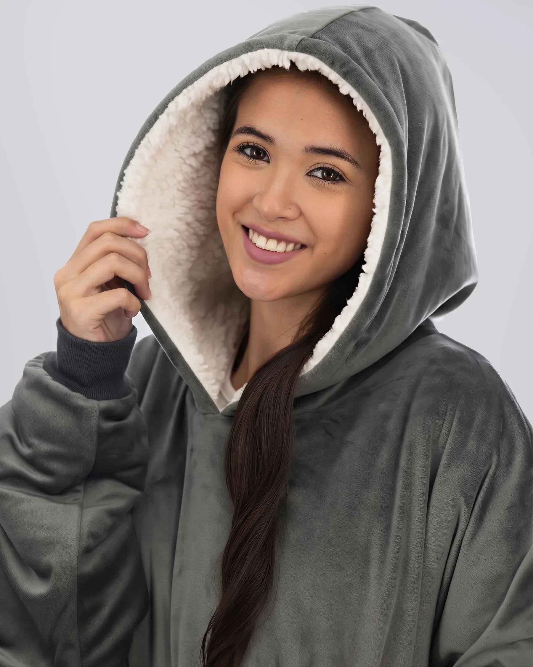 Close-up of woman wearing The Comfy Original Long in charcoal, highlighting hood and CloudSherpa™ lining.