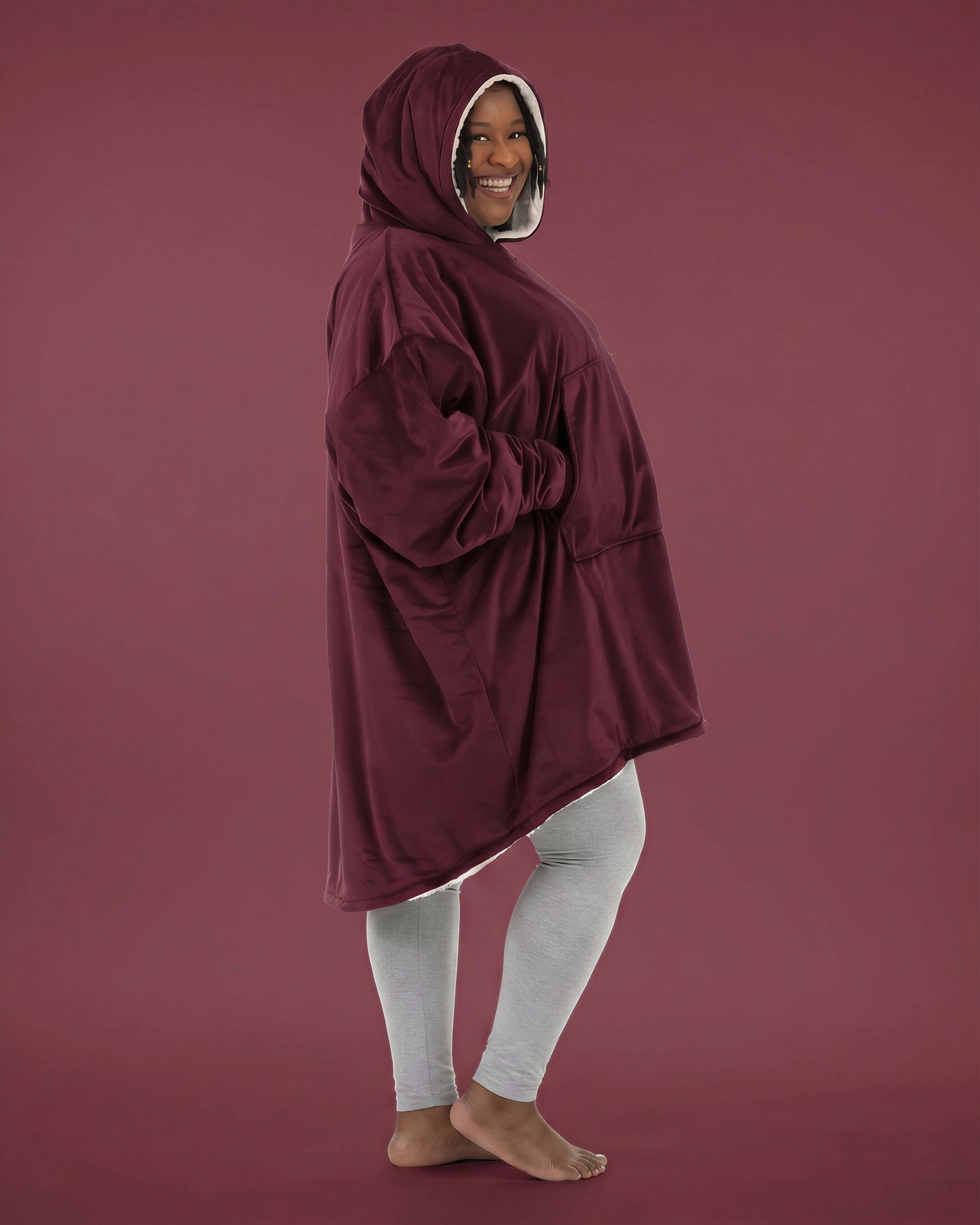 Side view of The Original wearable blanket in burgundy showing oversized fit and hood design