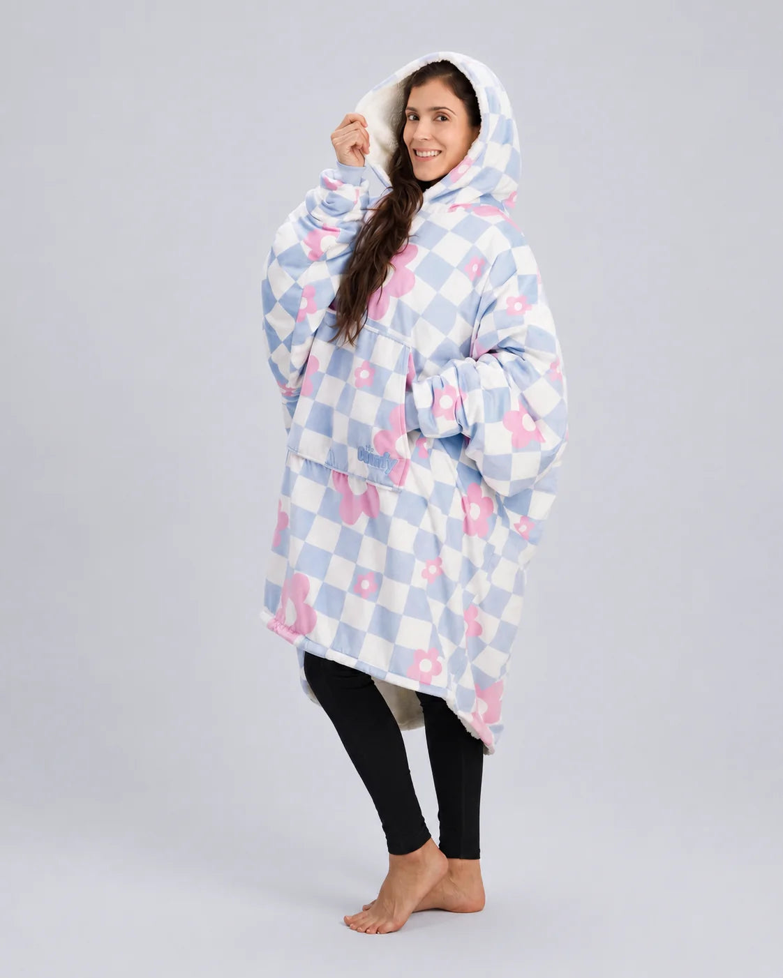 Side-angle lifestyle shot of The Original in Flower Checkered, highlighting the roomy hood, oversized fit, and ultra-soft Velveluxe™ exterior with all-over floral checkerboard print.