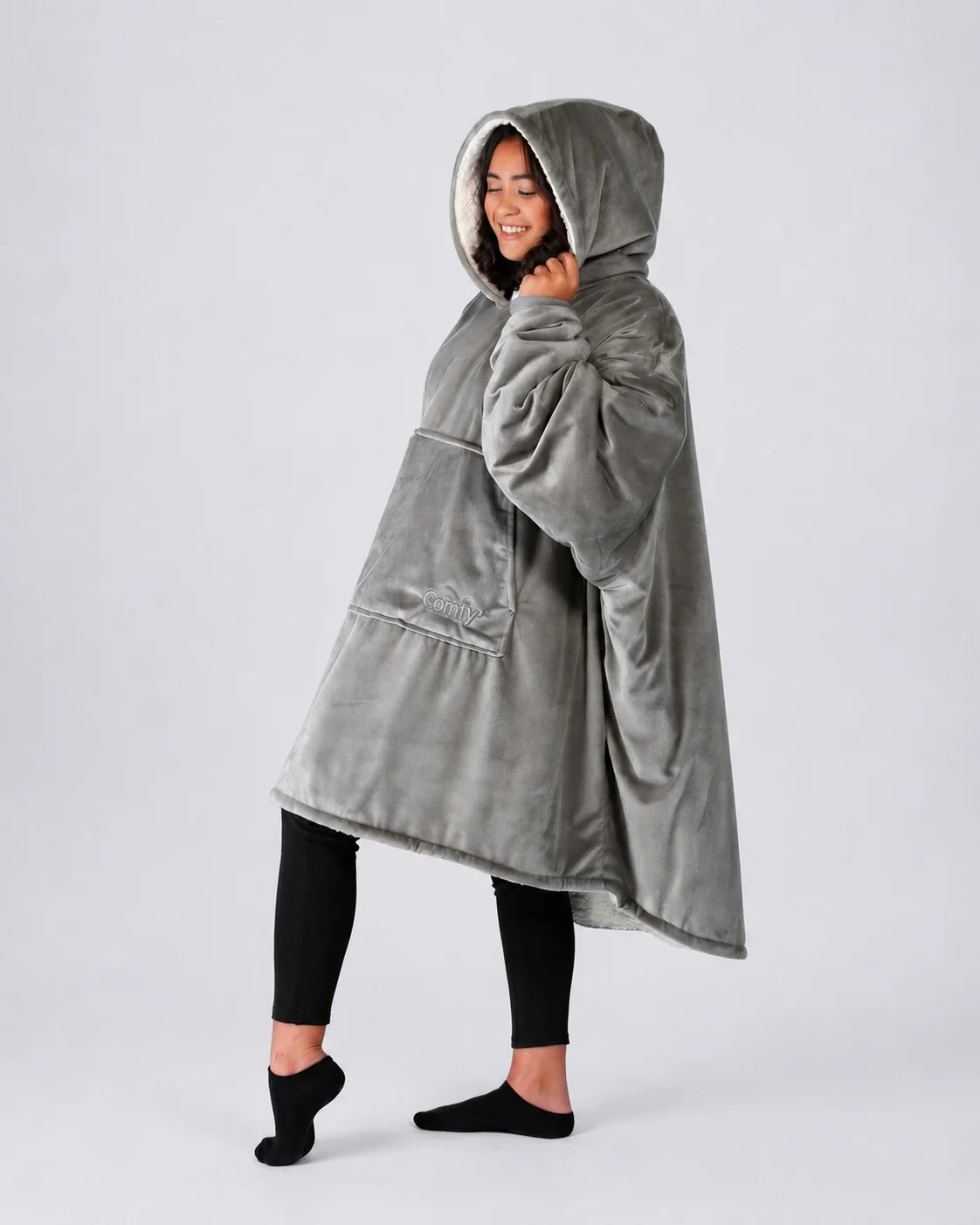 Side view of The Original wearable blanket in gray showing relaxed oversized fit and hood design