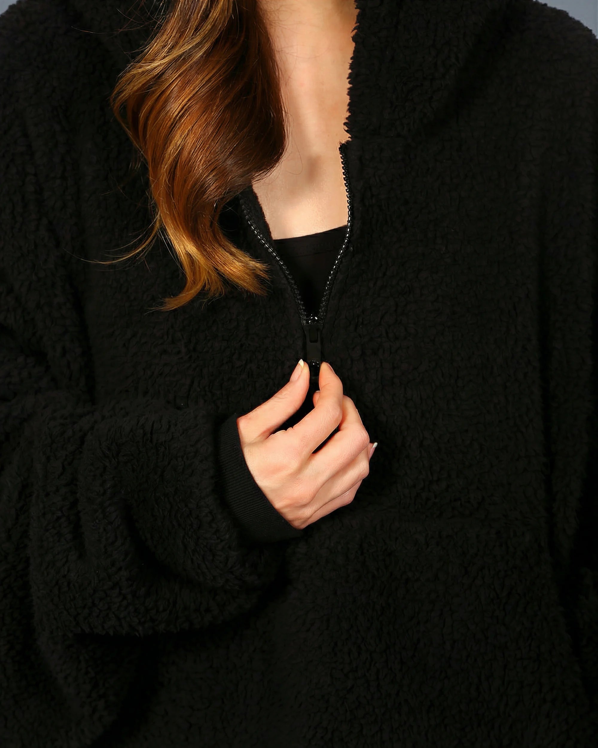 Close-up of The Teddy Bear Quarter-Zip wearable blanket in black highlighting quarter-zip neckline and plush CloudSherpa™ fabric