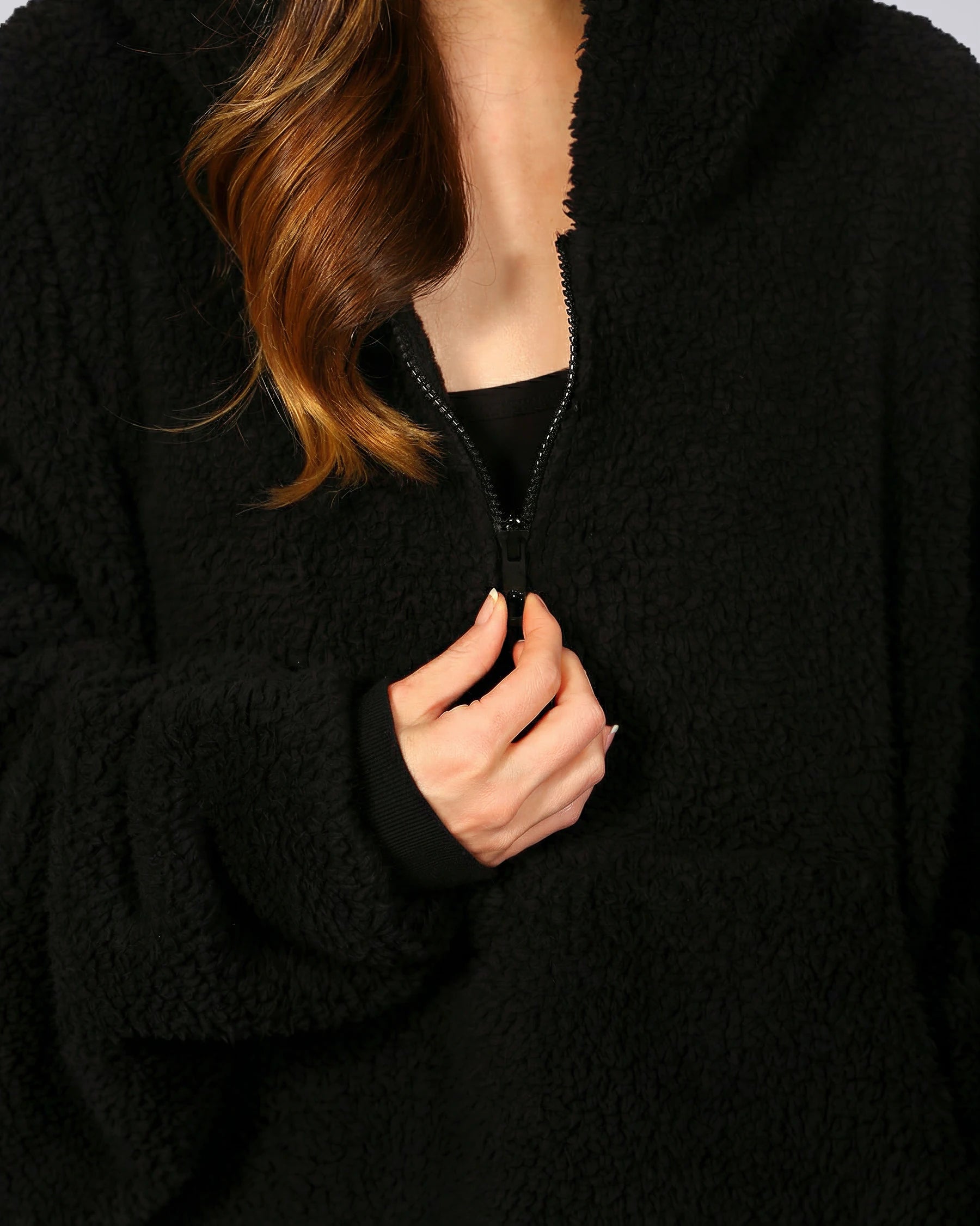 Close-up of The Teddy Bear Quarter-Zip wearable blanket in black highlighting quarter-zip neckline and plush CloudSherpa™ fabric