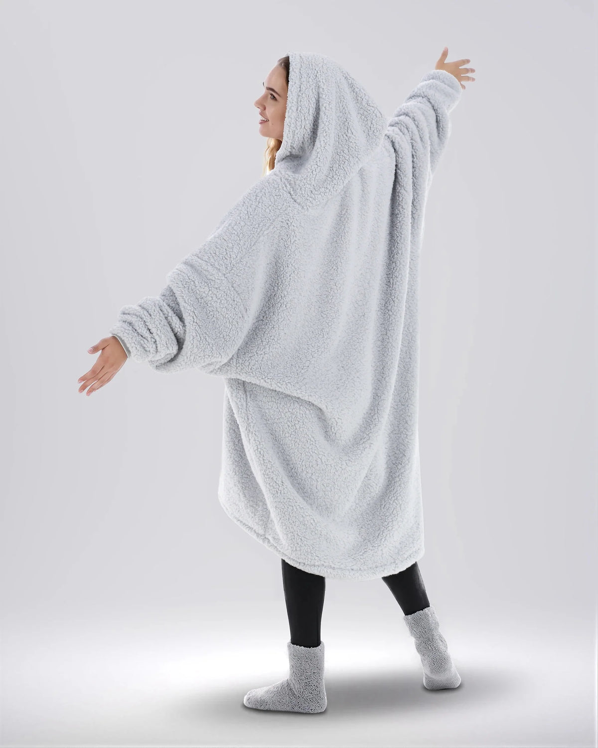 Back view of The Teddy Bear Quarter-Zip wearable blanket in light gray highlighting oversized drape and hooded silhouette