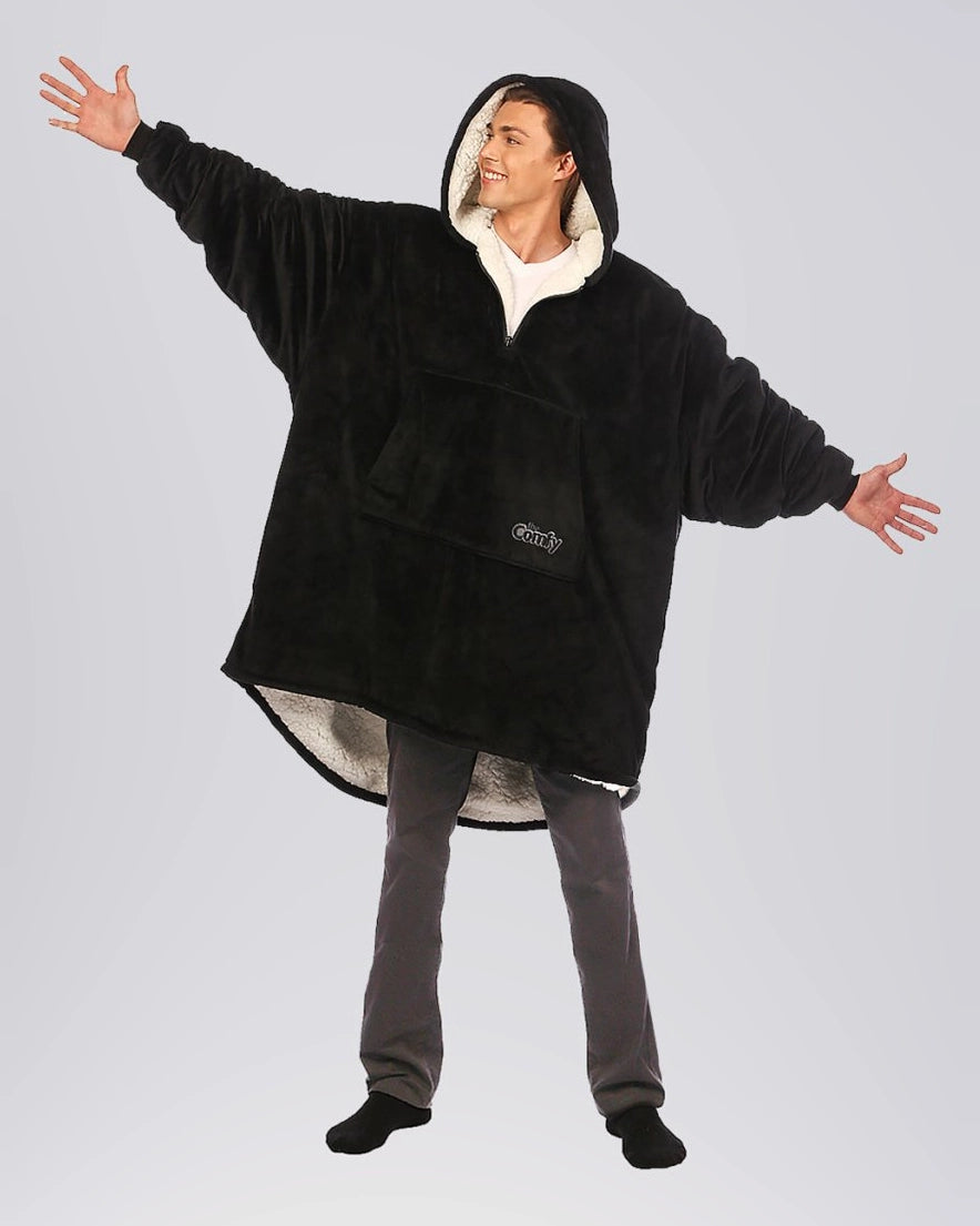 The Original Quarter-Zip wearable blanket in Black, front view with arms extended.