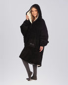 The Original Quarter-Zip wearable blanket in Black, front view with hood up.