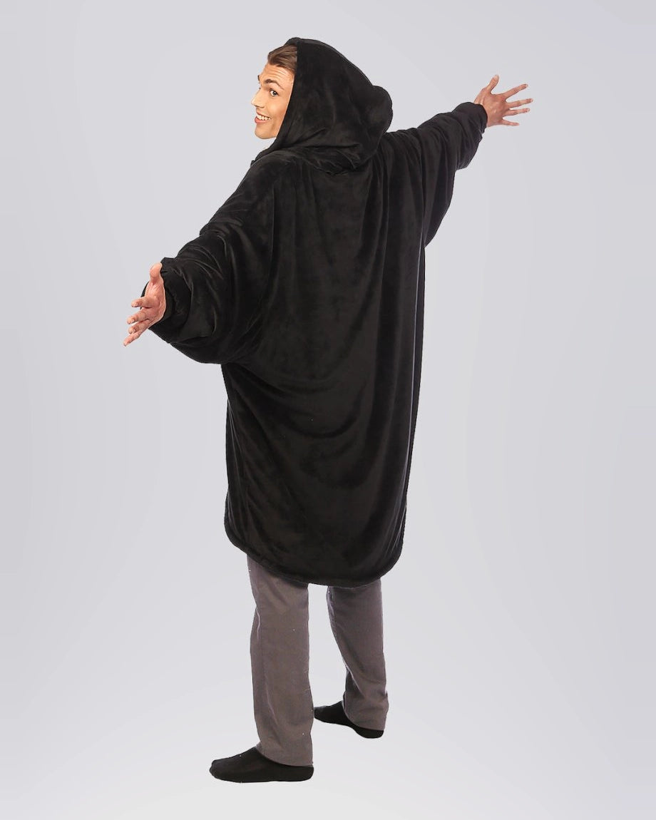 The Original Quarter-Zip wearable blanket in Black, rear view with arms extended.