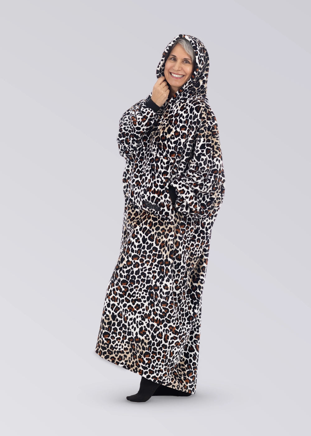 Side view of a woman wearing The Dream Long in Leopard with the oversized hood up.