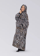 Side view of a woman wearing The Dream Long in Leopard with the oversized hood up.