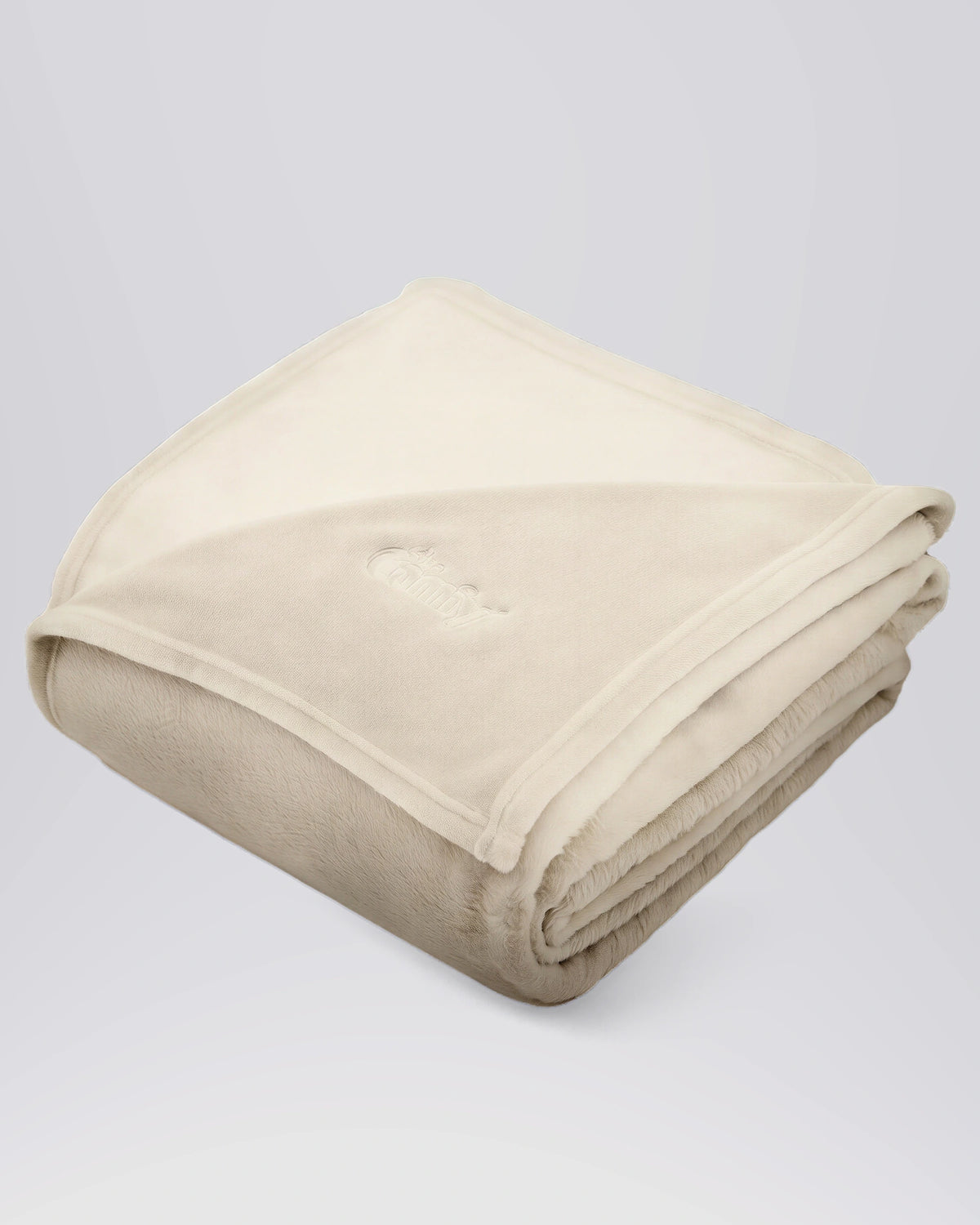 Folded Dream Big Blanket in Cream showing its soft fabric and embroidered logo.