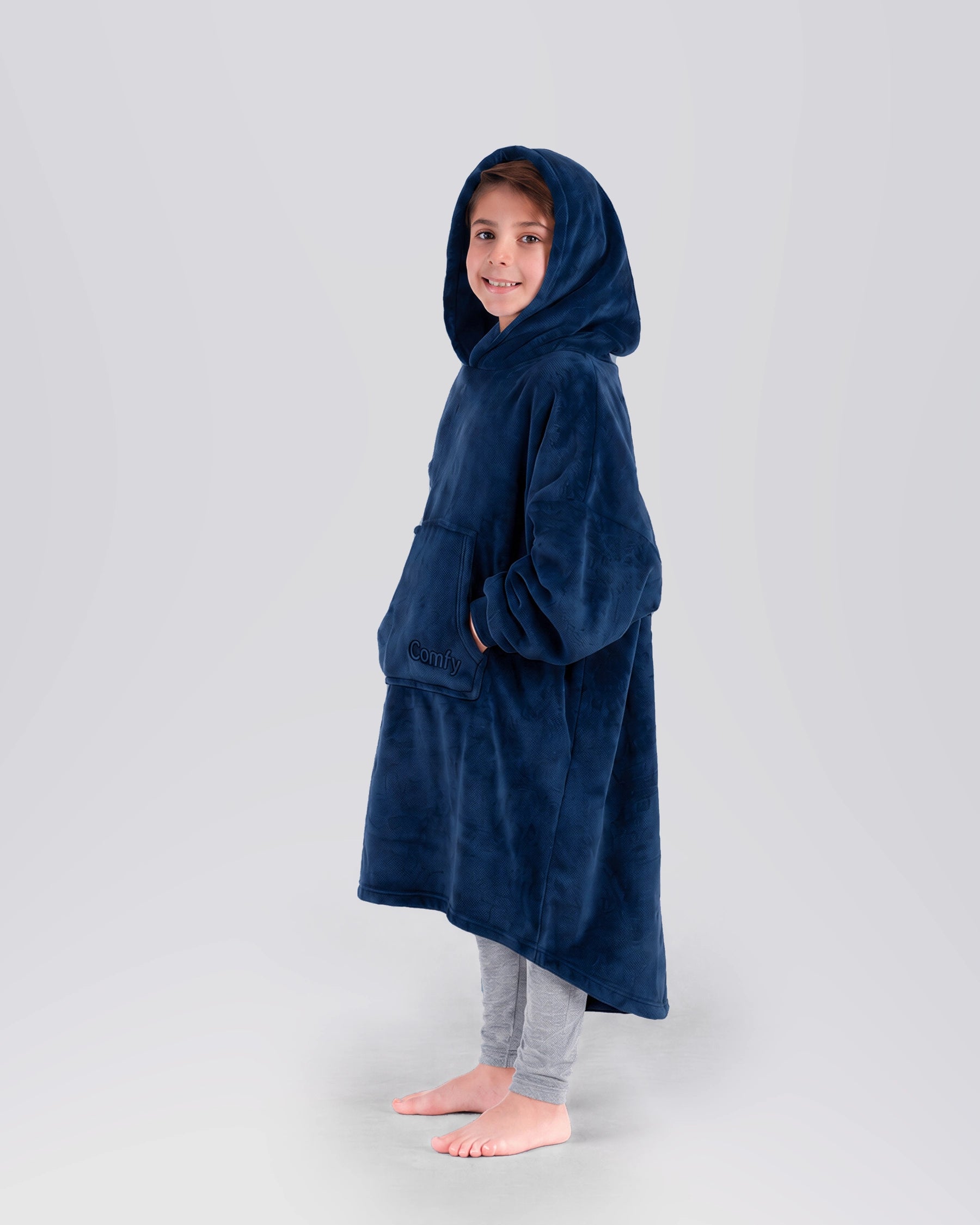 Side view of a child wearing The Dream Jr. in Sky Blue, showing the oversized hood and soft drape.