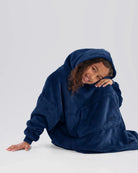 Model seated while wearing The Dream Jr. in Blue.