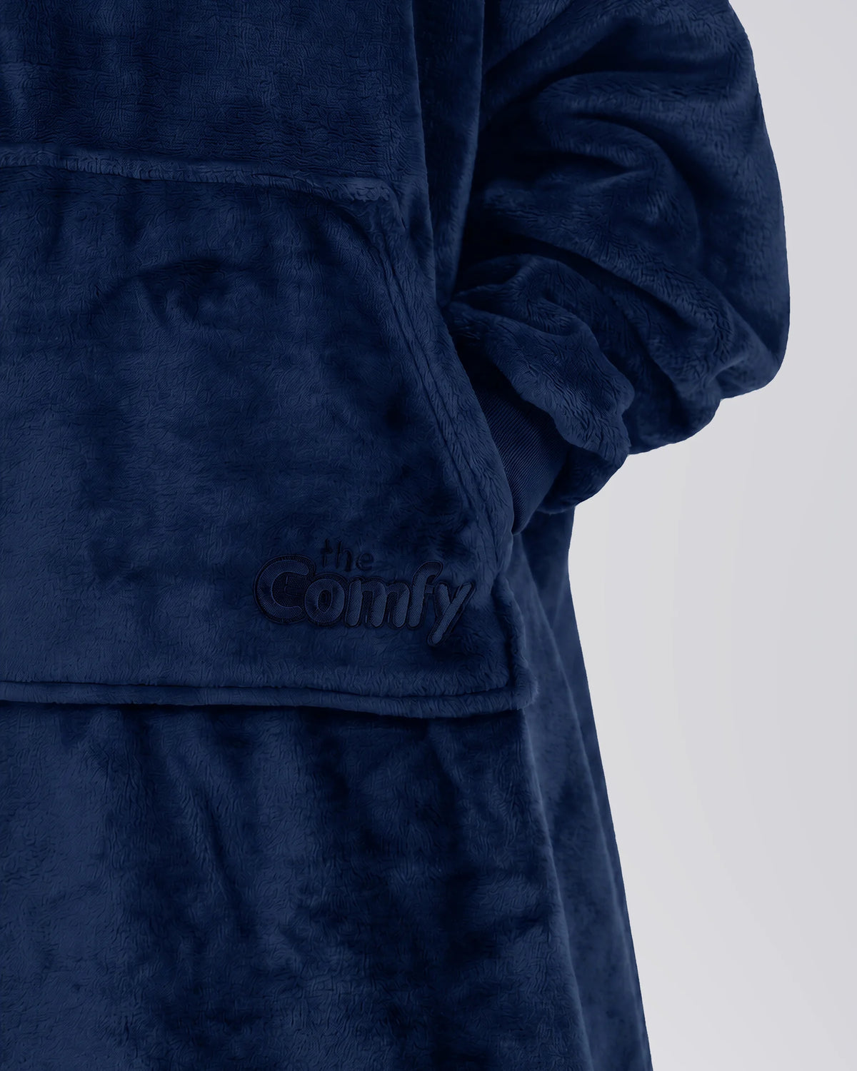 Close-up of The Dream Jr. in Sky Blue showing DreamHaven™ fabric, the front pocket, and tonal Comfy embroidery.