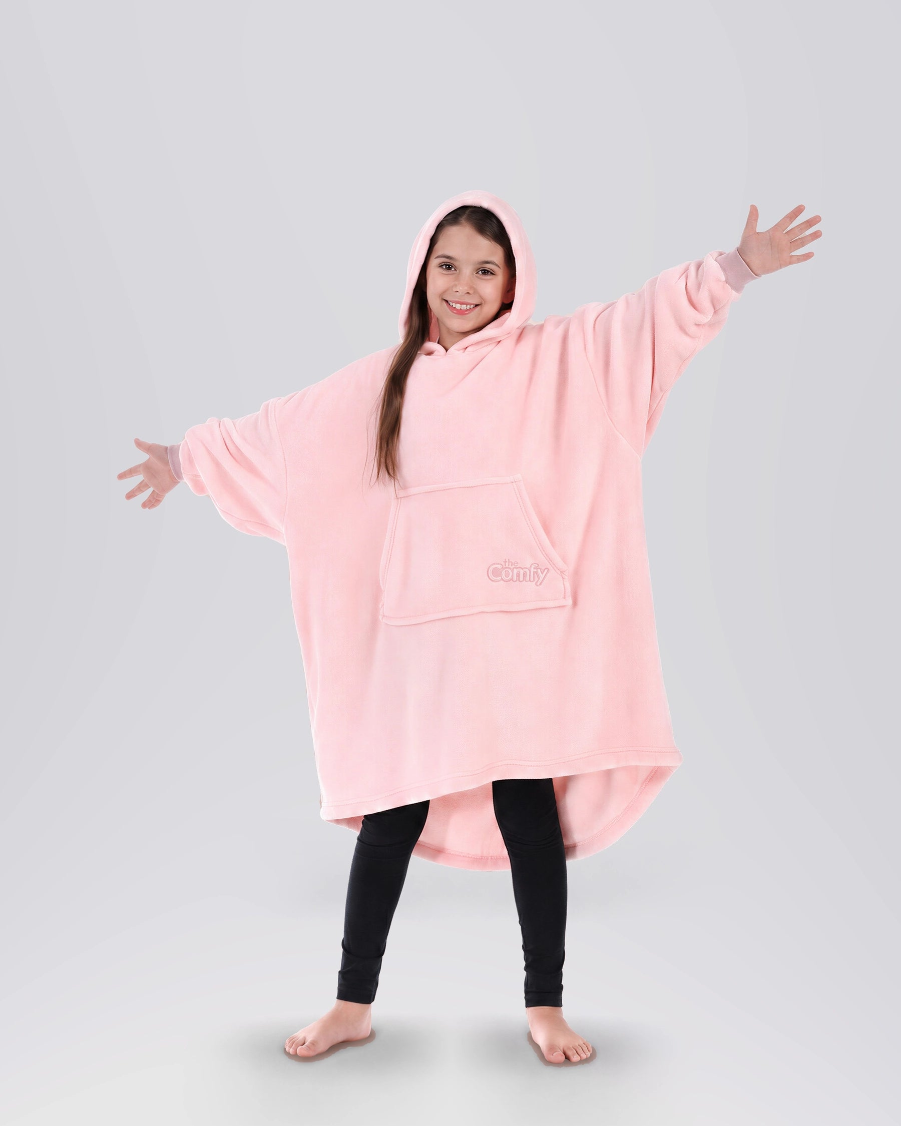 Child wearing The Dream Jr. in Heather Pink, showing the kid-sized oversized silhouette and hood.