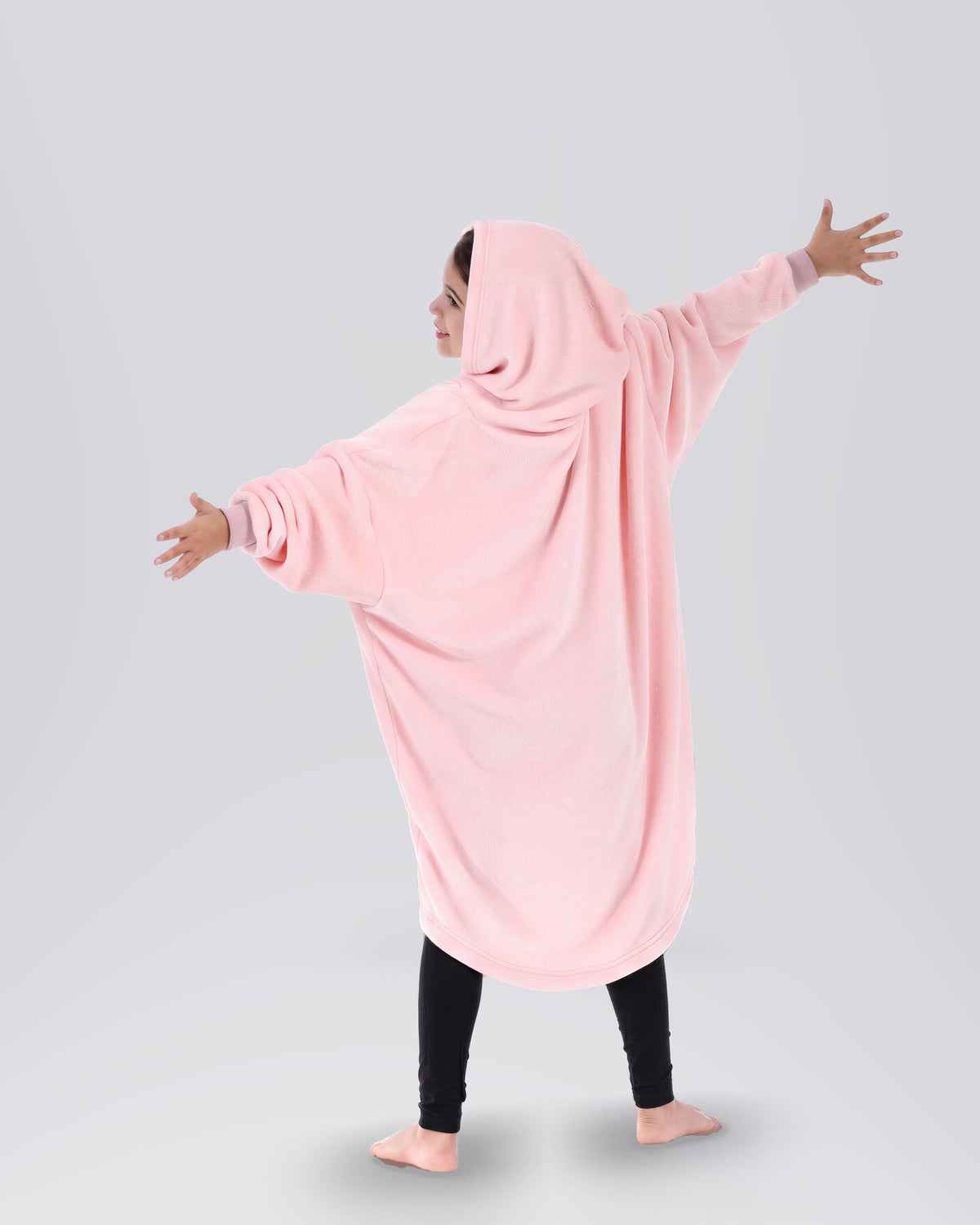 Back view of a child wearing The Dream Jr. in Heather Pink, showing the oversized hood and relaxed drape.