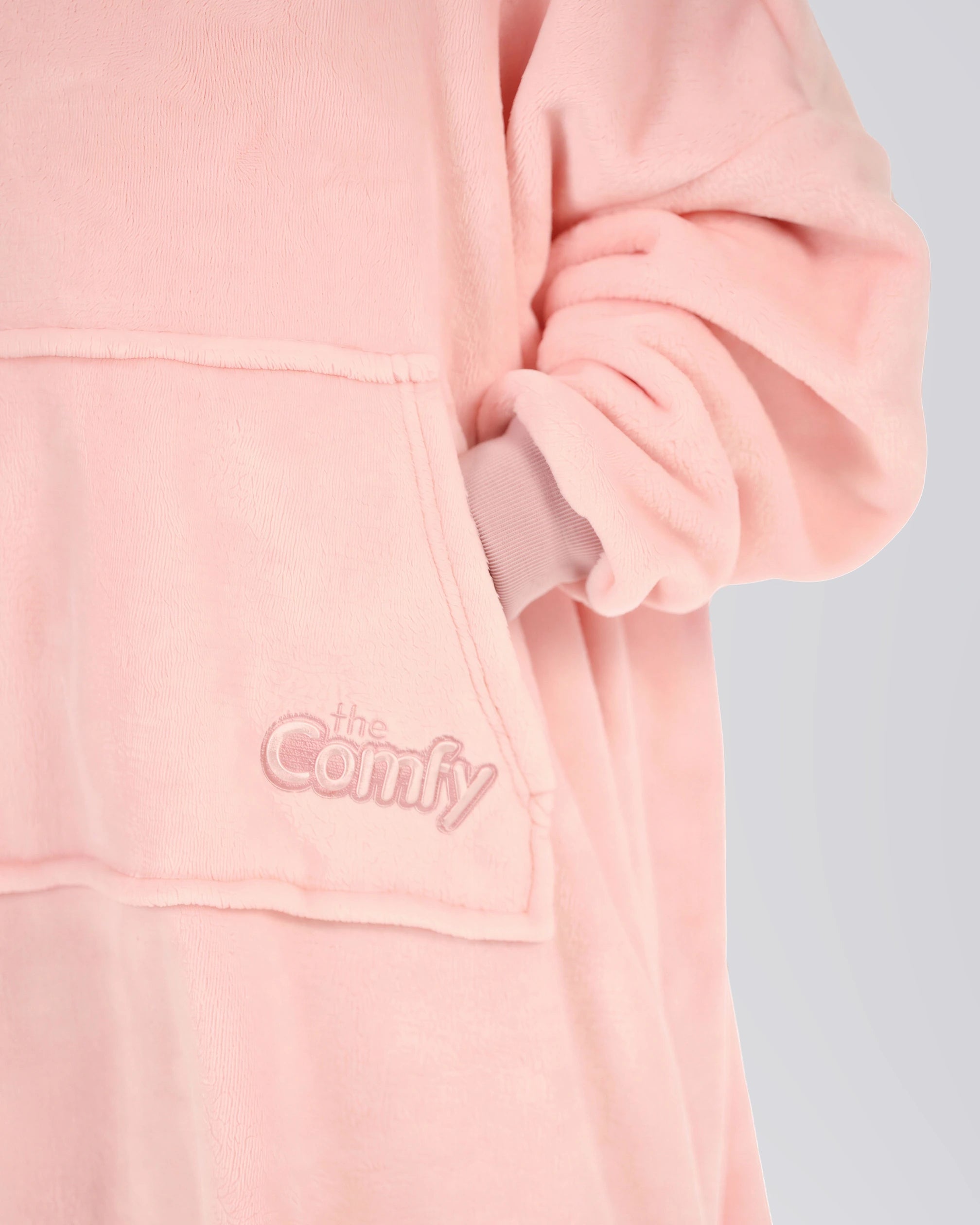 Close-up of The Dream Jr. in Heather Pink showing DreamHaven™ fabric, the front pocket, and tonal Comfy embroidery.
