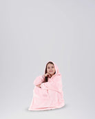 Child sitting comfortably in The Dream Jr. in Heather Pink, showing its soft drape and relaxed fit.