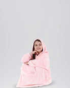 Model seated while wearing The Dream Jr. in Blush.