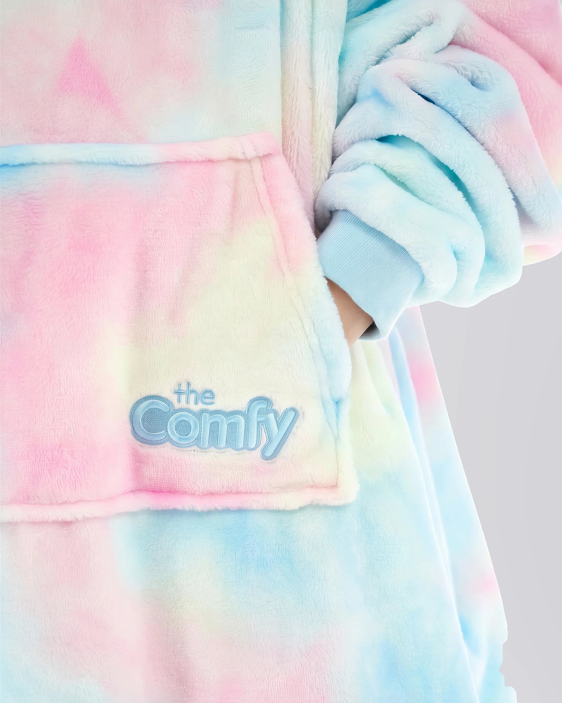 Close-up of The Dream Jr. in Cotton Candy Tie Dye showing DreamHaven™ fabric, the front pocket, and Comfy embroidery.