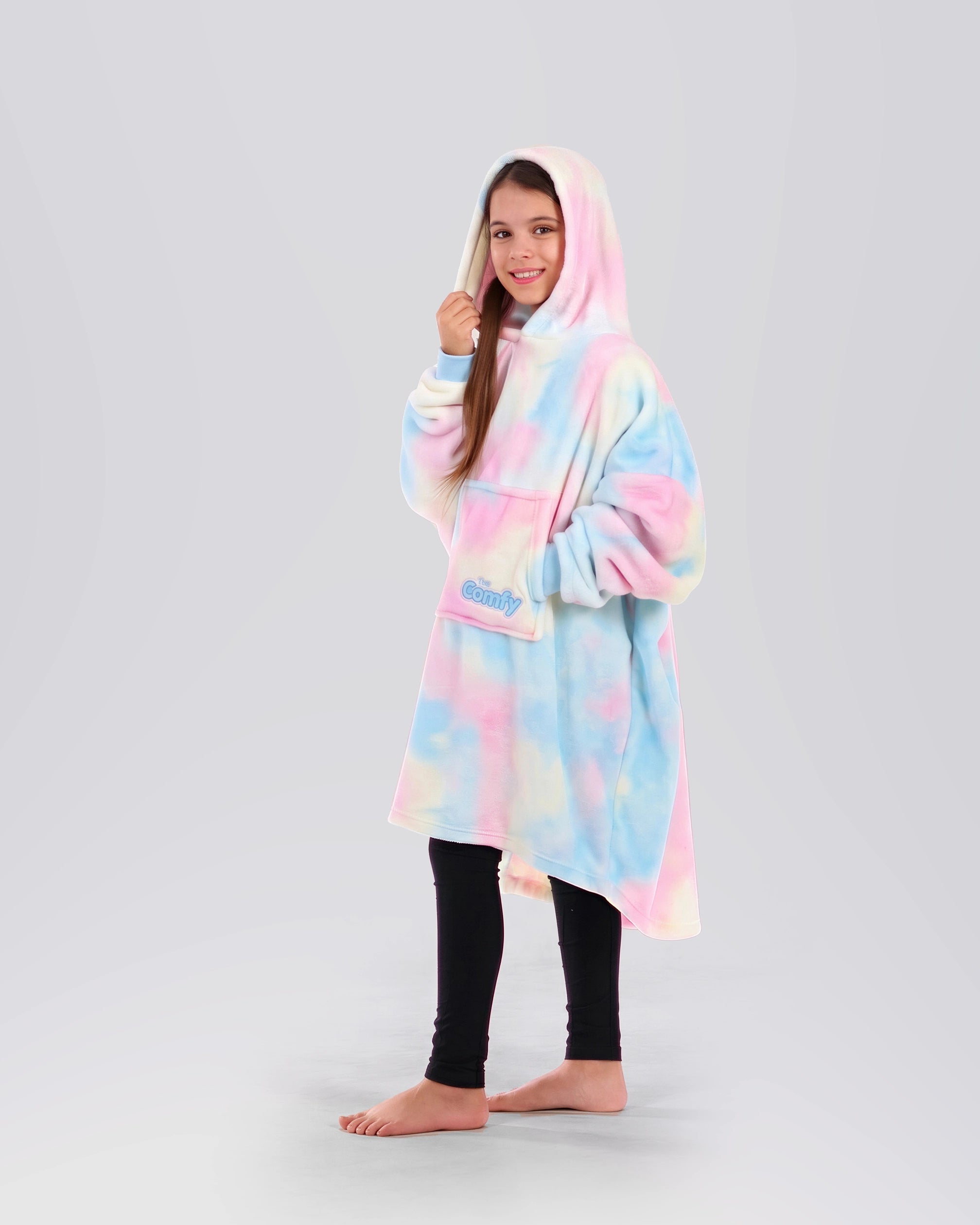 Side view of a child wearing The Dream Jr. in Cotton Candy Tie Dye, showing the oversized hood and easy drape.