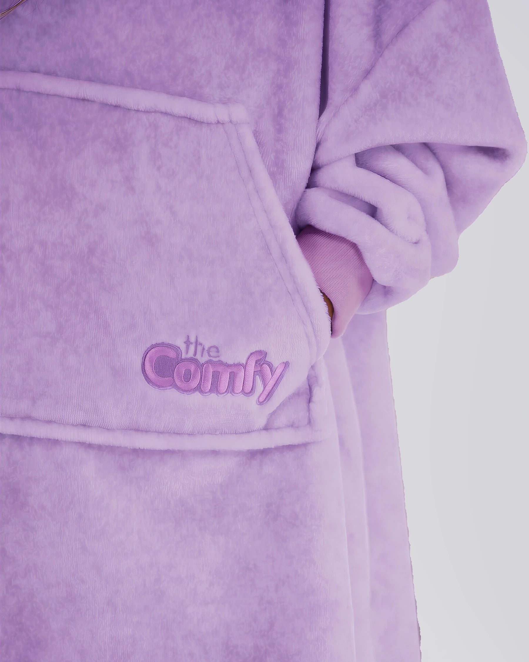 Close-up of The Dream Jr. in Heather Purple showing DreamHaven™ fabric, the front pocket, and Comfy embroidery.