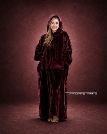 Woman standing in The Dream Long wearable blanket in Burgundy, showcasing the floor-length design and oversized fit.