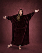 Woman with arms outstretched wearing The Dream Long in Burgundy, highlighting the oversized silhouette and full coverage.