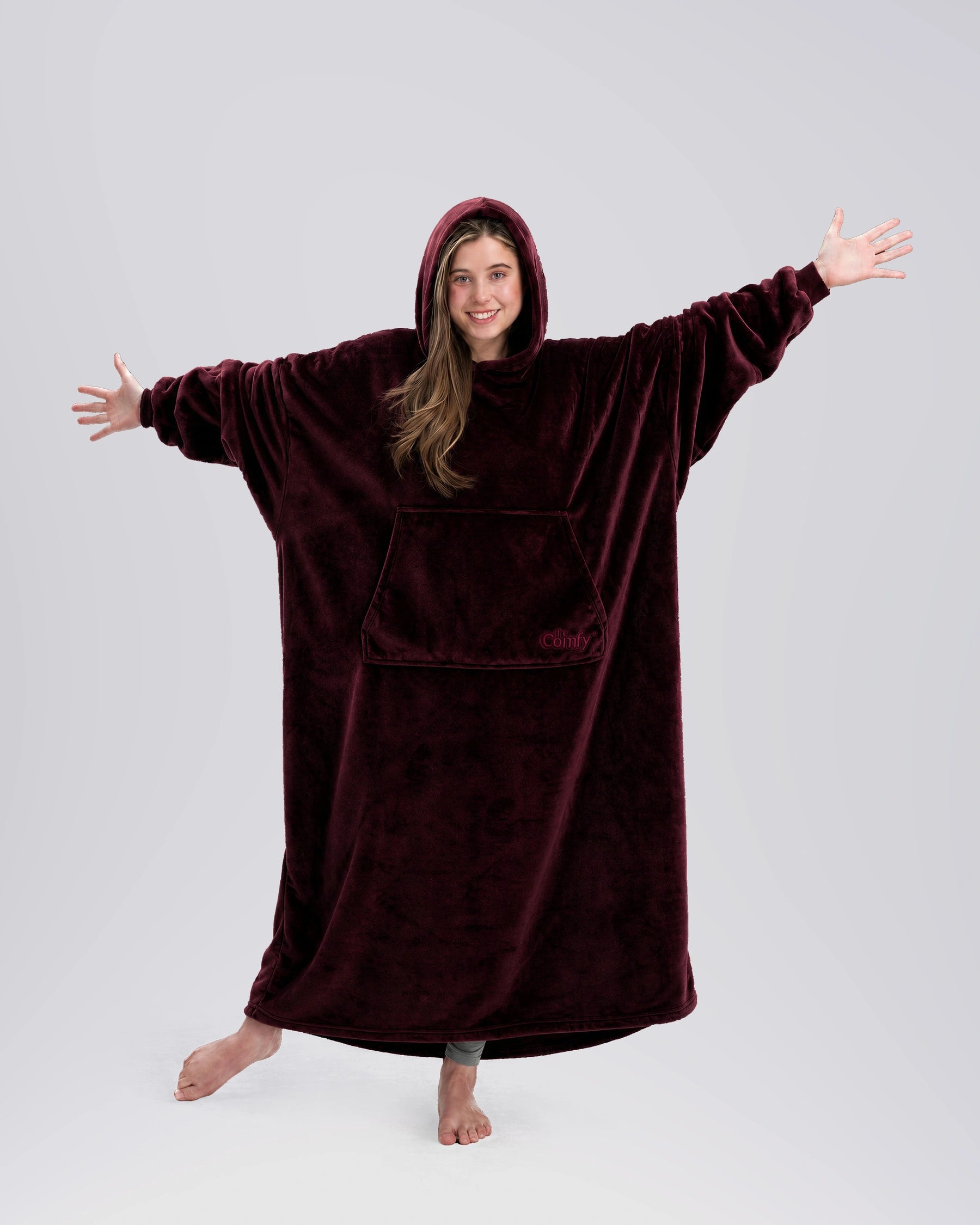 Woman standing with her arms out in The Dream Long in Burgundy, showing the full-length silhouette and relaxed drape.