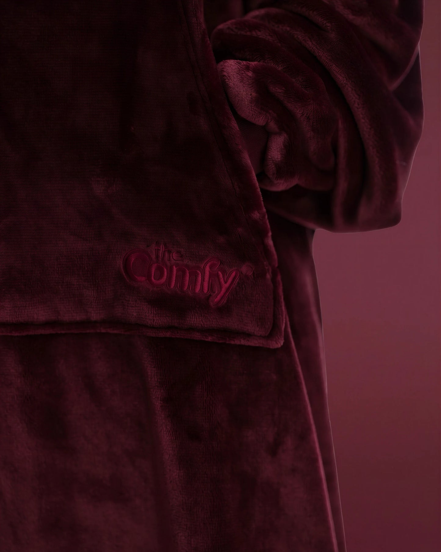 Close-up of The Dream Long in Burgundy featuring the soft microfiber fabric, front pocket, and embroidered The Comfy logo.