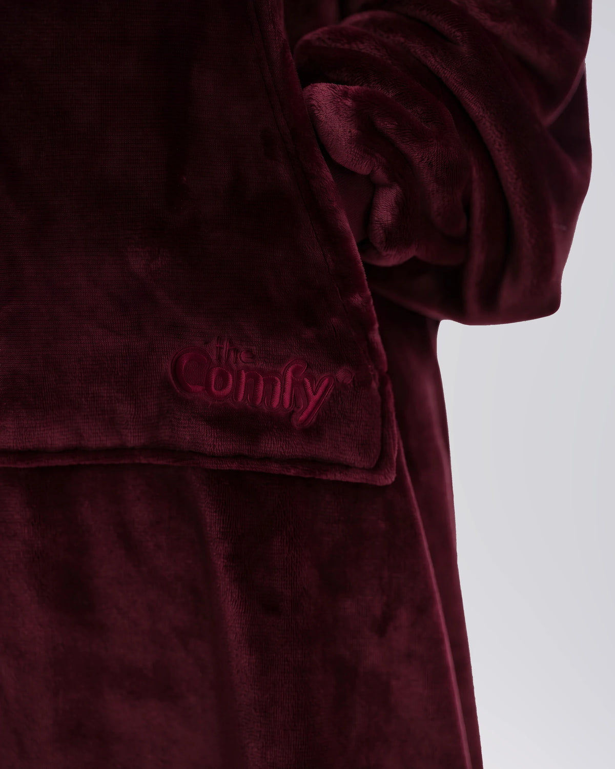 Close-up of The Dream Long in Burgundy showing DreamHaven™ fabric, the front pocket, and tonal Comfy embroidery.