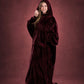 Woman wearing The Dream Long in Burgundy with hood up, showcasing the relaxed fit and full-length coverage.