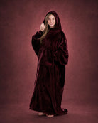 Woman wearing The Dream Long in Burgundy with hood up, showcasing the relaxed fit and full-length coverage.