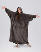 Woman standing with arms out in The Dream Long in Dark Gray, showing the full-length silhouette and relaxed drape.