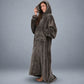 Side-profile view of a woman wearing The Dream Long with the hood up, highlighting the relaxed drape, oversized fit, and cozy kangaroo pocket.
