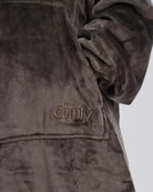 Close-up of The Dream Long in Dark Gray showing DreamHaven™ fabric, the front pocket, and tonal Comfy embroidery.