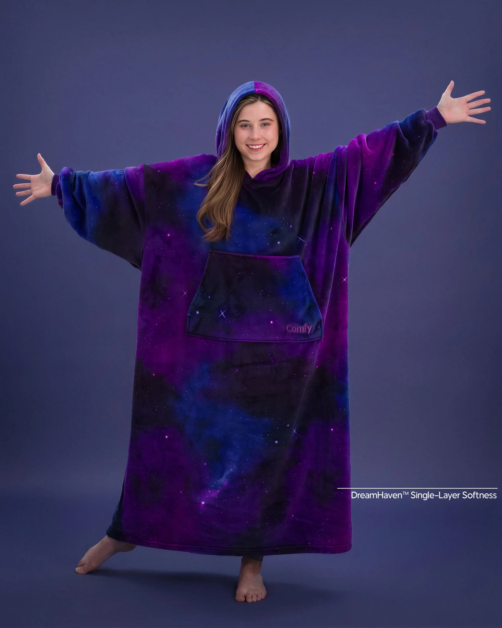 Woman with arms outstretched wearing The Dream Long in Galaxy, showcasing the floor-length design and all-over cosmic print.