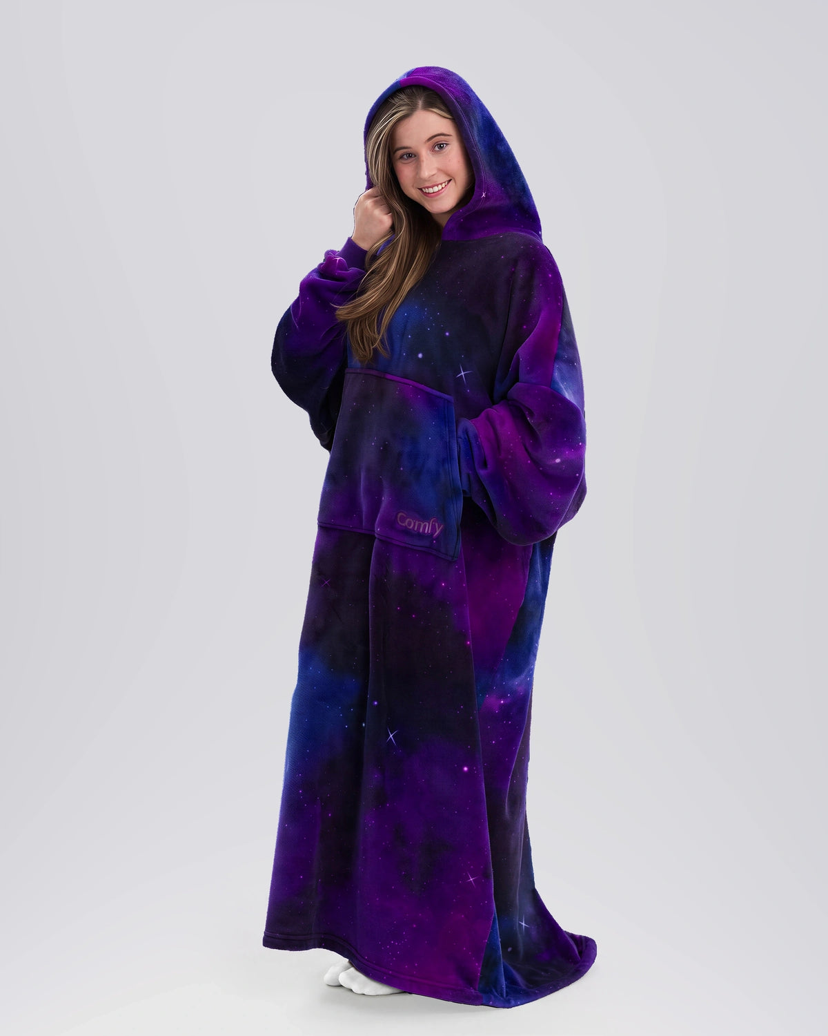 Front view of a woman wearing The Dream Long in Galaxy with the oversized hood up.